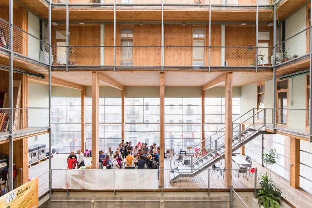 La Borda's shared courtyard, with timber galleries, stairs and communal facilities around the open space.