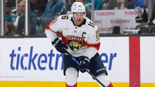 Aleksander Barkov of the Florida Panthers in a white road jersey, wearing the captain's C