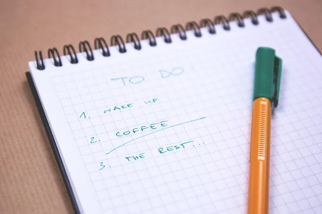 A hand checking items on a paper checklist