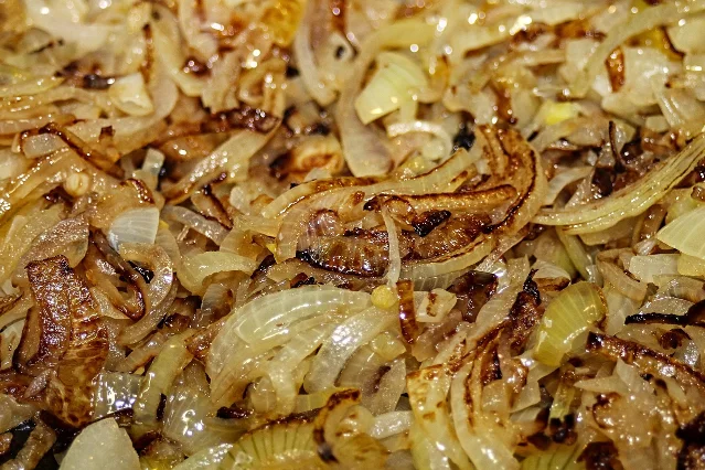 Chopped onions collapsed and browned in a frying pan
