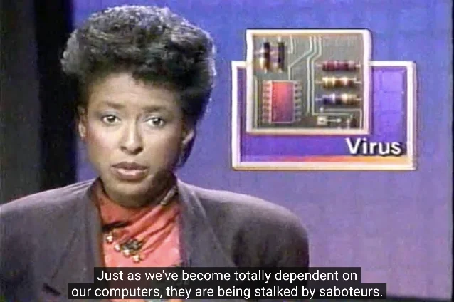 Television news report on the Morris worm: an anchor in a grey blazer and red scarf against a purple studio backdrop, next to an on-screen graphic of a circuit board labelled "Virus"
