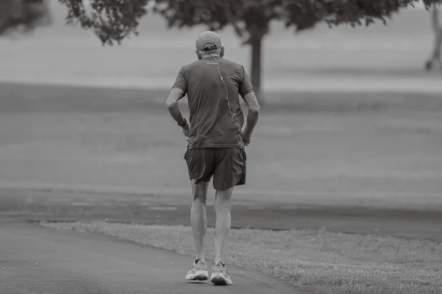 An older man jogging through a park at dawn — regular aerobic activity is the most evidence-backed exercise for preserving executive function