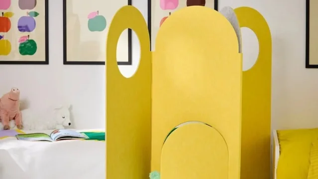 A yellow GREJSIMOJS room divider anchoring a compact living space