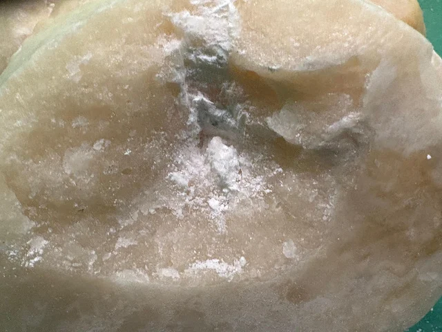 Close-up of the interior of one statue, showing white powder residue packed inside a hollowed-out stone cavity