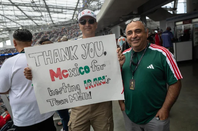 Iran supporters thank Mexico before the Belgium match