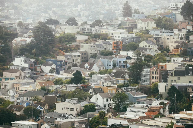 Colorful residential houses on foggy San Francisco hills