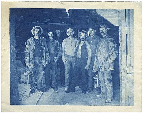 Comstock miners in the 1880s, posed at the mine entrance