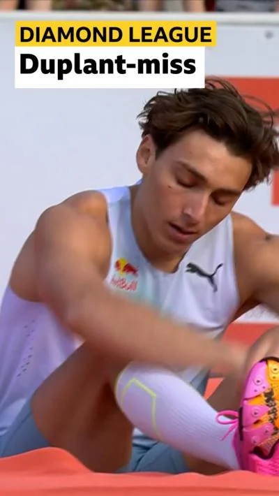 Armand Duplantis crouched on the landing mat at Stockholm Olympic Stadium after a failed attempt, BBC 'Duplant-miss' text overlay visible