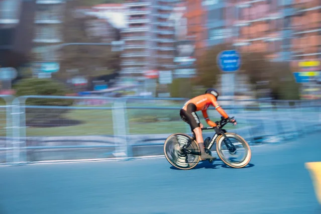 Race cyclist at full speed through a city street with strong motion blur