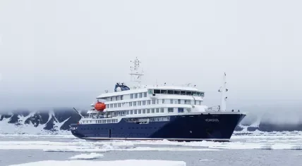 MV Hondius in polar ice with orange life rafts on davits