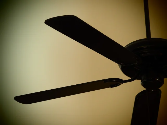 Ceiling fan in a home room with wooden blades