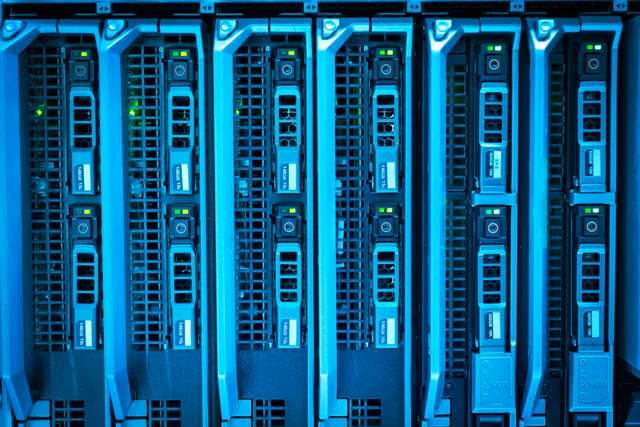 Illuminated server racks in a managed data center — the kind of infrastructure DXC operates for banks and airlines