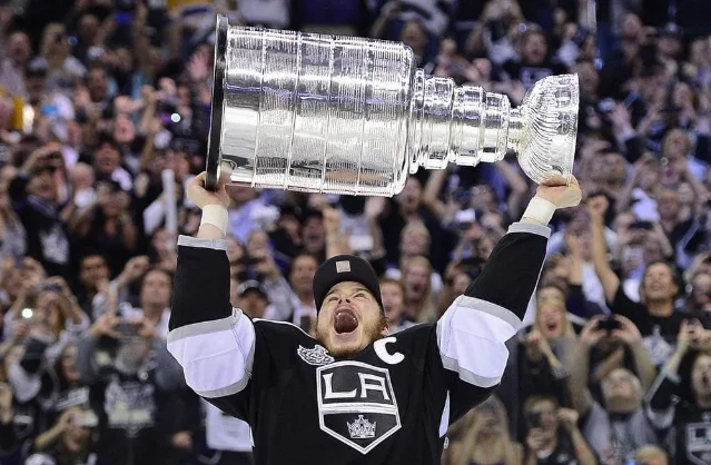 Kings captain Dustin Brown raises the Stanley Cup at Staples Center after the Kings' 6–1 win in Game 6