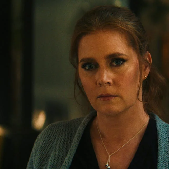 Amy Adams in a dimly lit room in a scene from Cape Fear