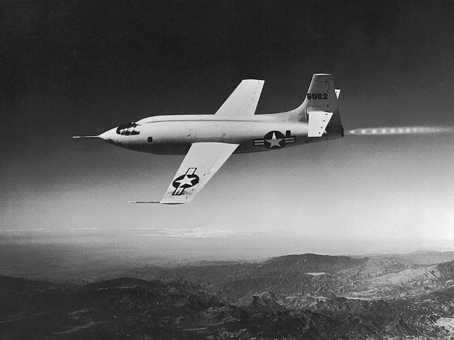 Bell X-1 serial 46-062 in flight over the Mojave Desert, rocket engine firing