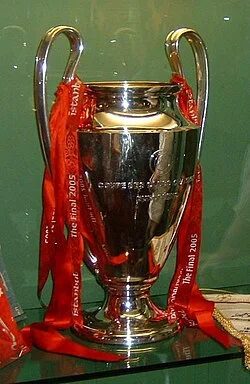 The 2005 European Champion Clubs' Cup trophy on display with red Liverpool ribbons