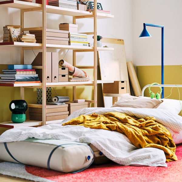Skiftebo chair-bed unfolded into single-bed configuration with bedding