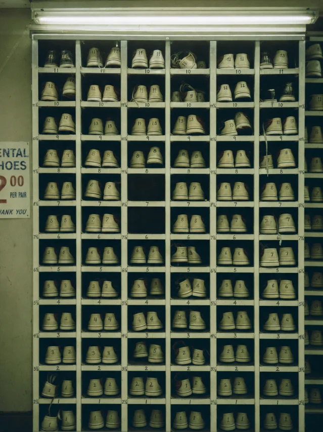 Floor-to-ceiling rental shoe rack, numbered cubbies