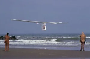 The Gossamer Albatross skimming over the beach at Cap Gris-Nez, France, as two people watch from the shore on June 12, 1979