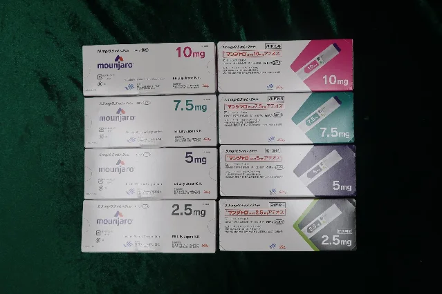 Eight Mounjaro (tirzepatide) boxes in Japanese packaging on a green cloth; four dose strengths (2.5mg, 5mg, 7.5mg, 10mg) in colorful GIP/GLP-1 boxes each reading Eli Lilly Japan K.K.