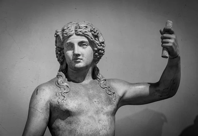 Ancient Roman marble statue of a god — the kind of Olympian figure before whom Julian imagined the emperors competing for favor in the Caesars