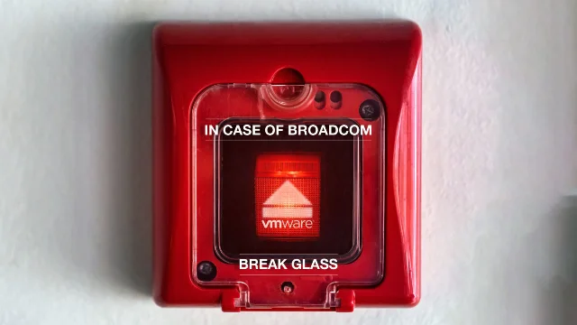 Ars Technica cover image: "IN CASE OF BROADCOM — BREAK GLASS" fire alarm box with VMware logo inside