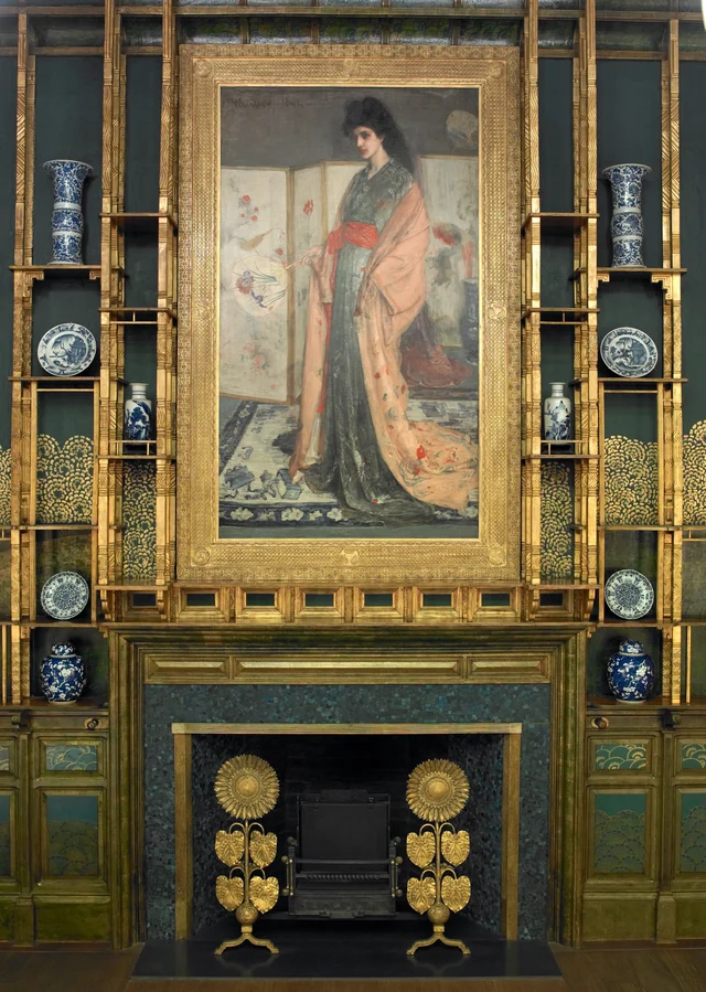 The Princess from the Land of Porcelain above Jeckyll's sunflower andirons, with gilded shelves flanking the fireplace