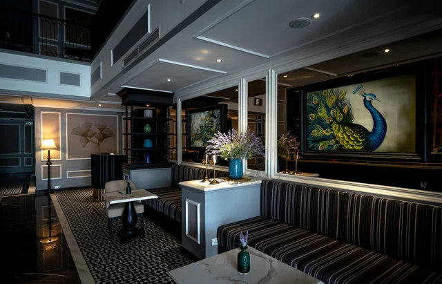 Opulent hotel lobby interior with plush seating, art, and mood lighting — representing the Hotels.com, Hyatt, and travel offers expiring June 30