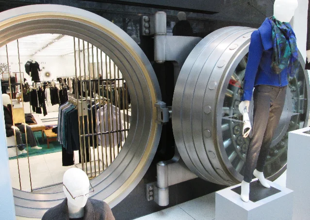 A circular bank vault door used as a retail display backdrop