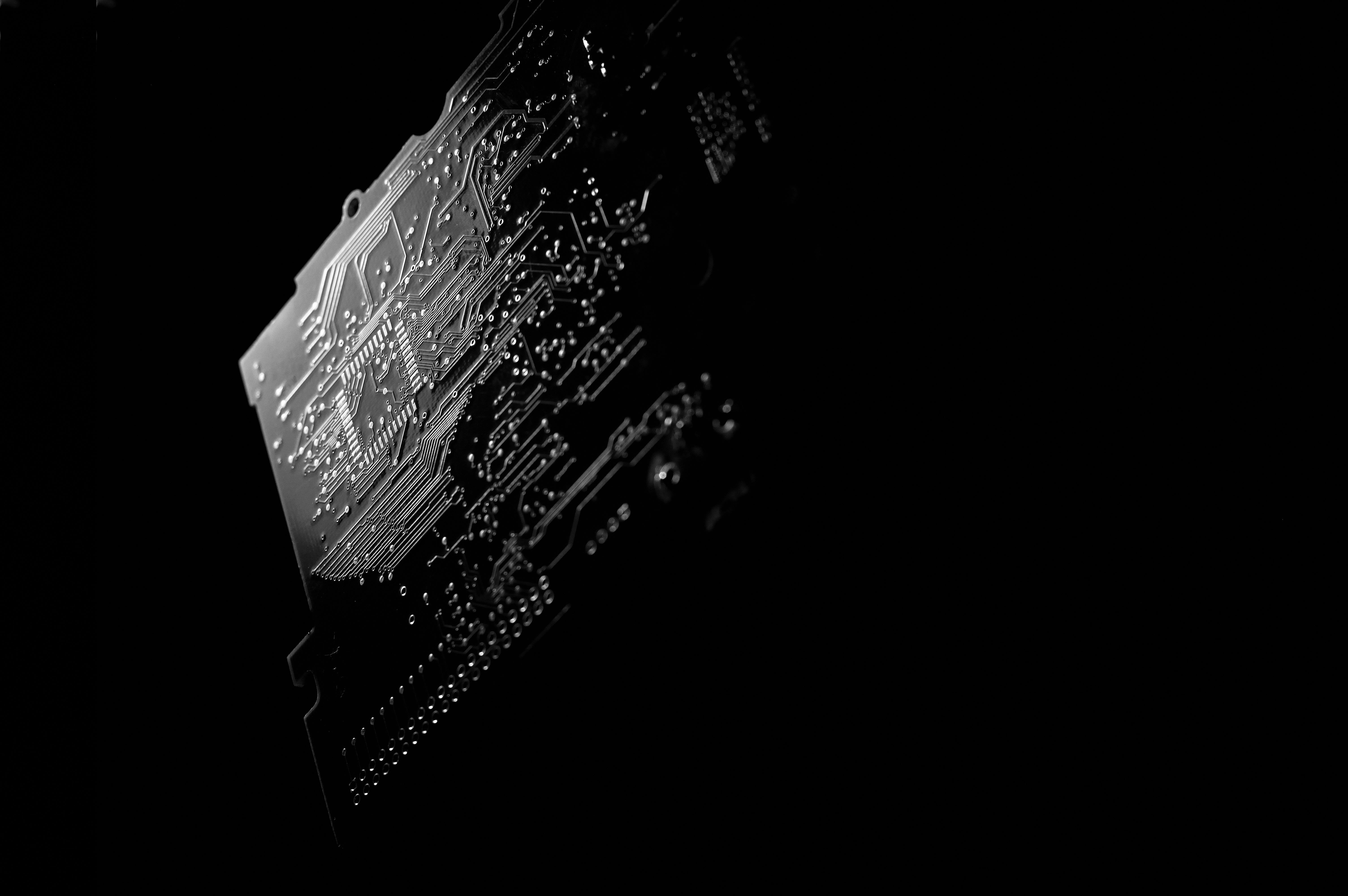 Monochrome PCB circuit board — close-up on copper traces and solder points
