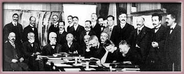 1911 Solvay Conference group photograph — Marie Curie, the sole woman, sits at center surrounded by the era's leading physicists