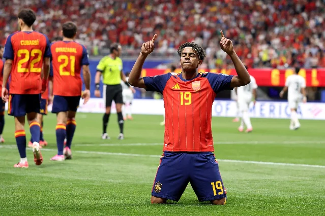 Lamine Yamal kneels and kisses the pitch after scoring his first World Cup goal against Saudi Arabia, Atlanta