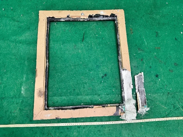 A dismantled canvas frame showing white powder concealed inside