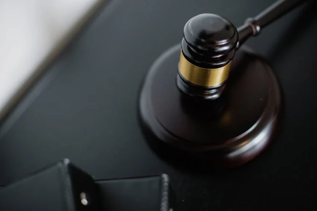 Wooden gavel on a courtroom desk — the OpenAI trial played out in Judge Gonzalez Rogers' San Francisco courtroom across days 3 and 4