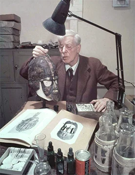 Herbert Maryon with his first reconstruction of the Sutton Hoo helmet, photographed around 1951.