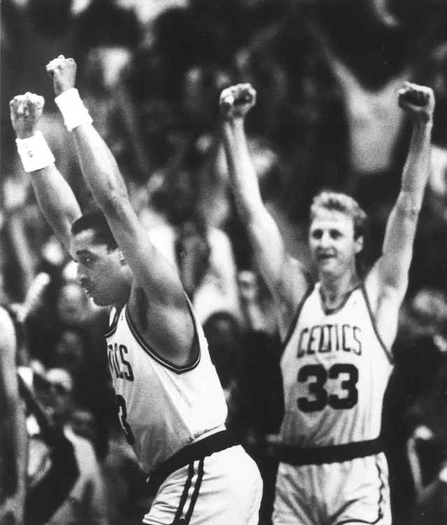 Larry Bird and Dennis Johnson raise their hands in victory after the game-winning play, Boston Garden, May 26, 1987