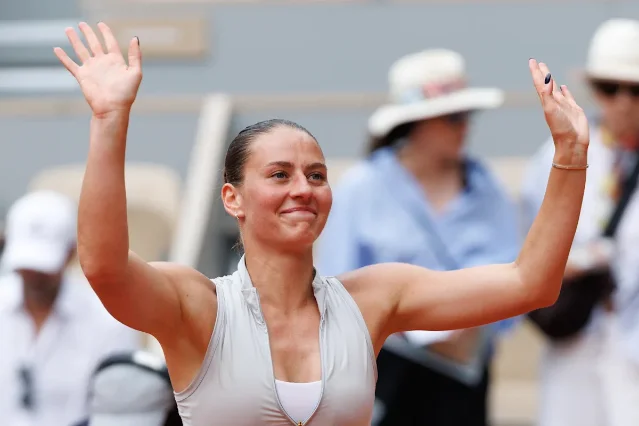 Świątek reacts during her fourth-round loss to Kostyuk