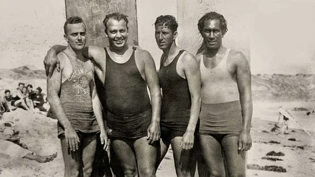 The four rescuers photographed together on the beach a few days after the event — from left: Gerry Vultee, Owen Hale, Bill Herwig, and Duke Kahanamoku (far right)