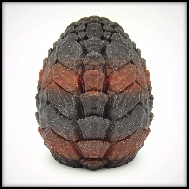 Stone Crawler Dragon Egg reverse side — same stone-fragment surface pattern from a different angle, dark grey and red-brown