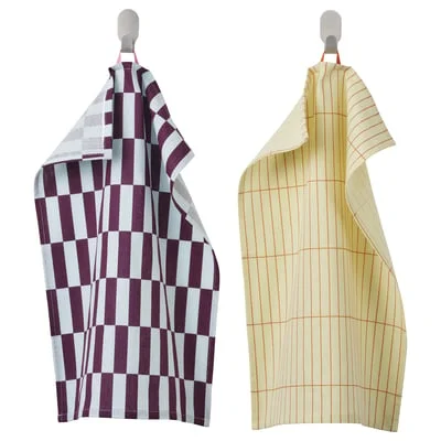 SPJUTLILJA dish towels — purple-white checkerboard and yellow grid patterns hanging on hooks