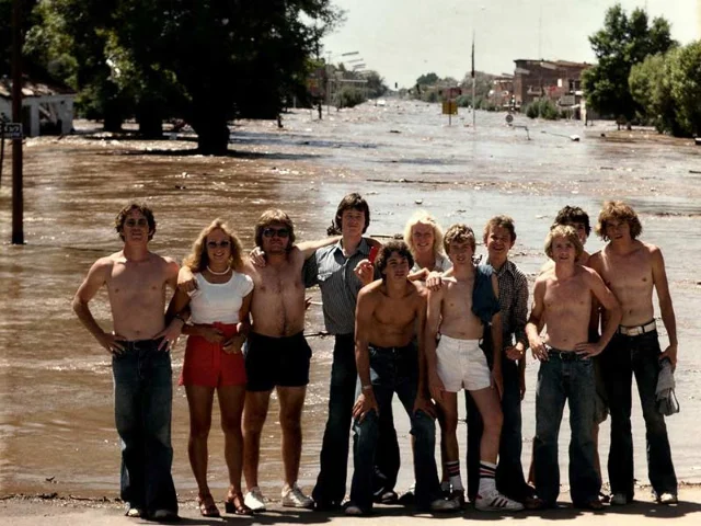 The Gibson brothers and friends photographed on the corner of Main Street and North 2nd East in Rexburg, hours after the flood — one of the defining images of the disaster's aftermath