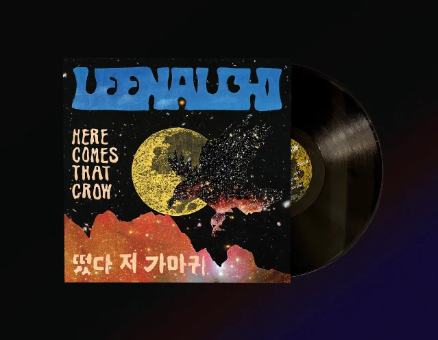 The *Here Comes That Crow* vinyl — sleeve showing the crow crossing the yellow moon, record partially out of the sleeve