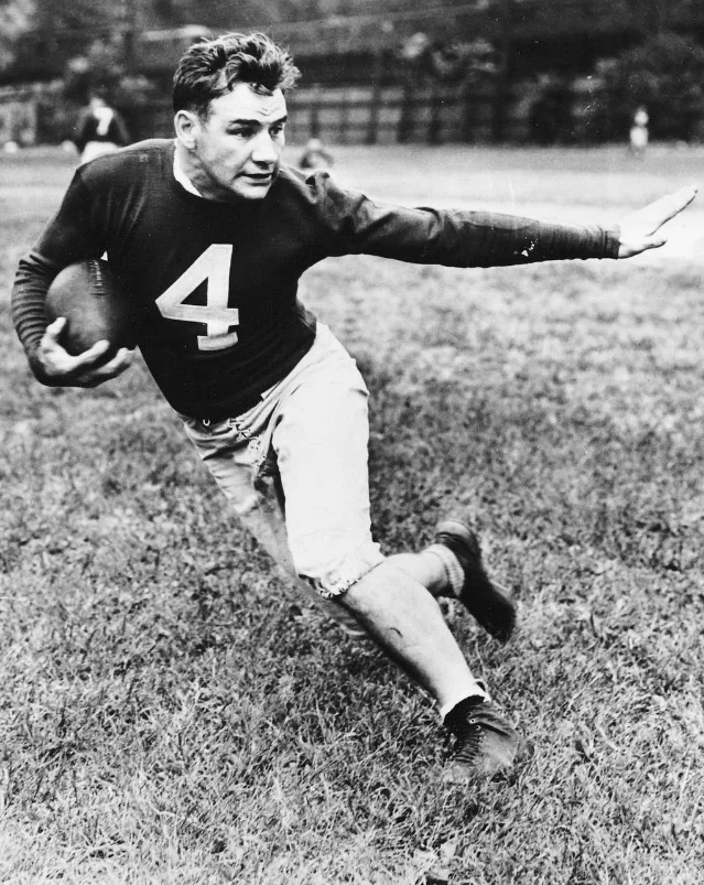 Tuffy Leemans running with the ball in a dark Giants jersey numbered 4