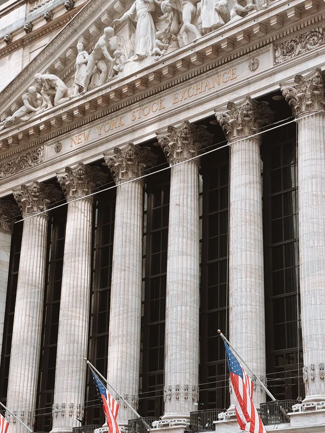 New York Stock Exchange facade with columns and American flags