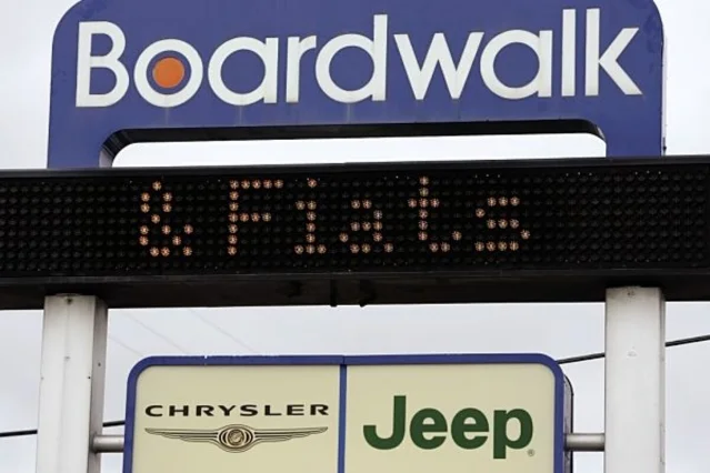 Chrysler Jeep dealership sign in Redwood City, California, with a scrolling ticker — one of hundreds of franchises facing closure in the 2009 restructuring
