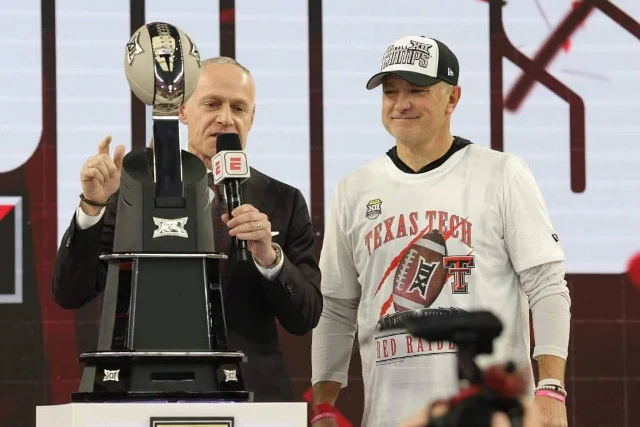 Big 12 commissioner Brett Yormark with Big 12 championship trophy alongside Texas Tech coach Joey McGuire