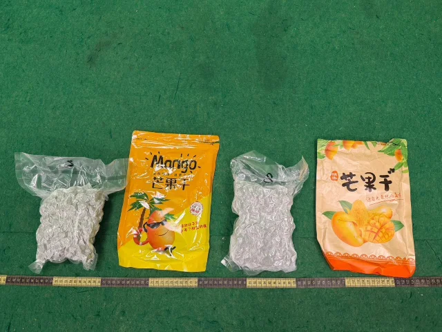 HK Customs official evidence photo: 4.5 kg suspected cannabis buds camouflaged as snacks, seized from Bangkok passenger's carry-on backpack