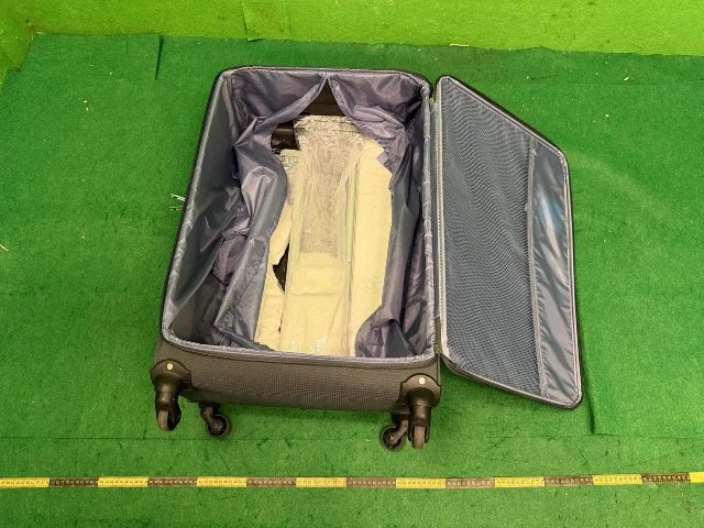HK Customs official evidence photo: 5 kg suspected ketamine found in false compartments of checked suitcase, Paris-route passenger