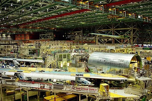 Boeing 747 final assembly at the Everett factory, showing fuselage sections under the overhead gantry cranes