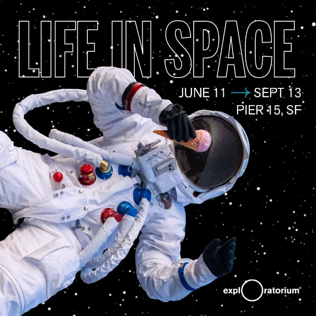 Exploratorium After Dark: Life in Space exhibition poster — astronaut in white spacesuit floating weightless while holding an ice cream cone, exhibition dates June 11 – September 13, Pier 15 San Francisco
